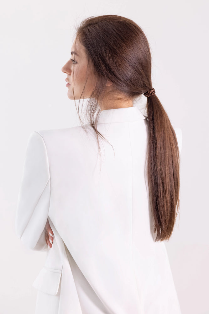 A brown-haired girl with ponytail is wearing brown Malkiele designer silk scrunchie