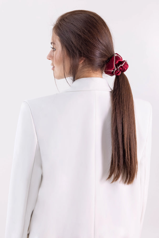 A brown-haired girl with ponytail is wearing burgundy Malkiele designer silk scrunchie, embellished with Swarovski pearls