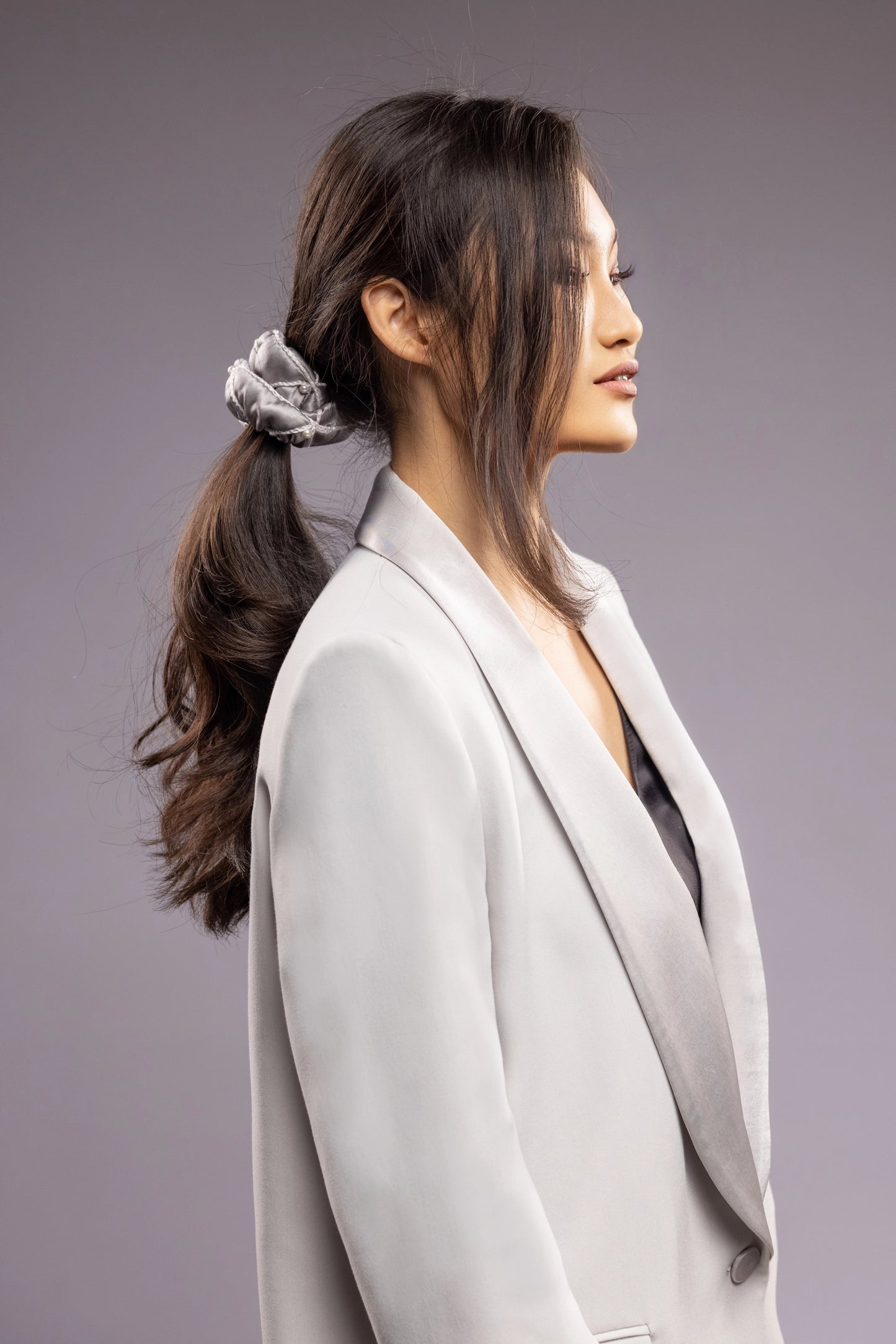 Asian beautiful girl business style with ponytail is wearing grey Malkiele designer silk scrunchie