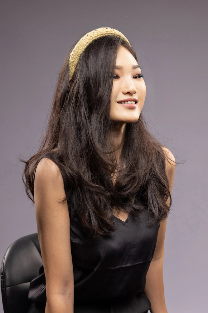 Asian smiling girl is wearing yellow Malkiele designer silk knit headband