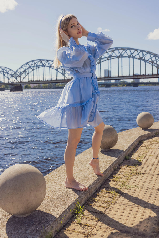 A blonde-haired girl is wearing light blue Malkiele designer silk knit headband