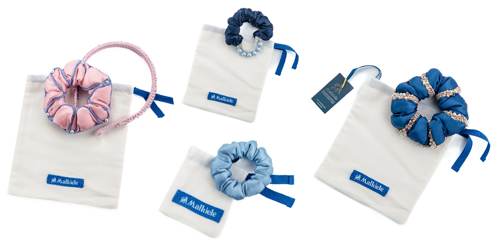 Many silk scrunchies and one headband are placed on Malkiele designer Premium cotton double dust bags.