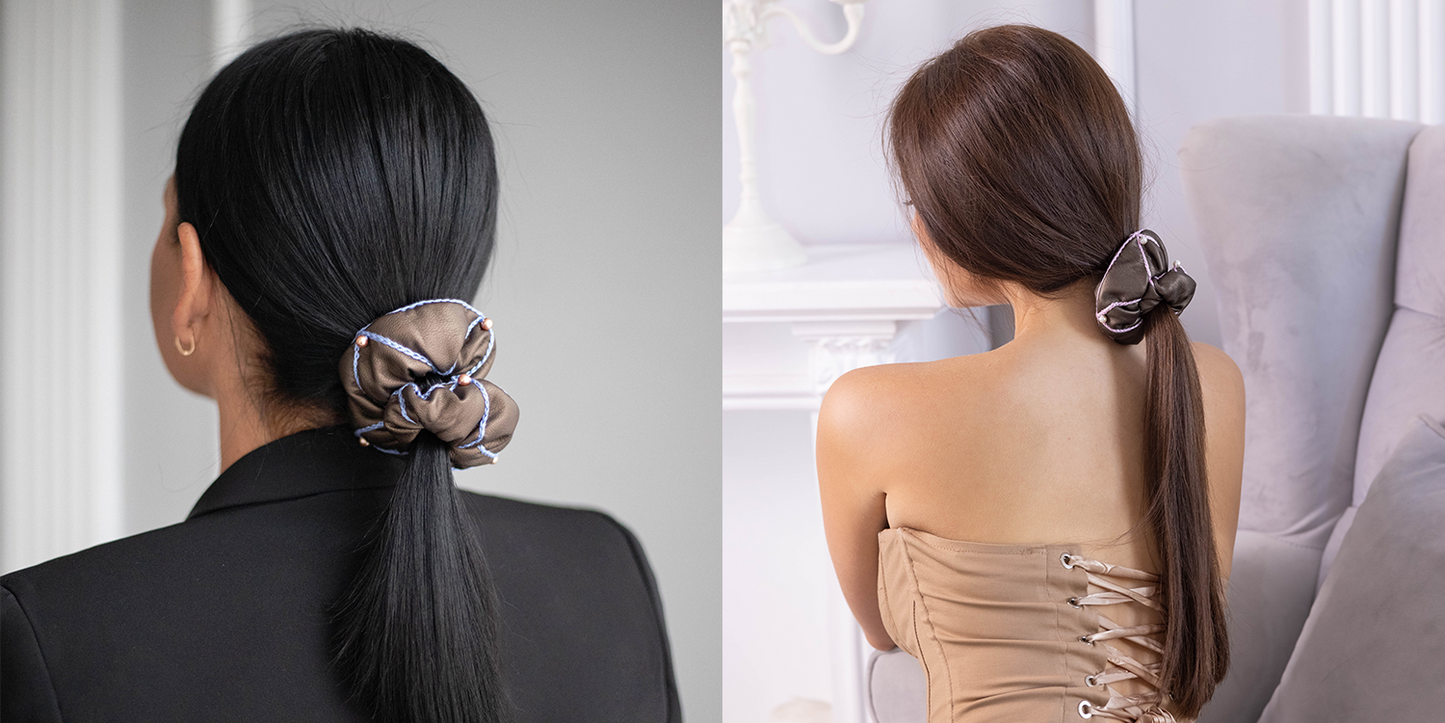 Two girls with trendy ponytails are wearing Malkiele designer vegan leather scrunchies with Swarovski pearls.