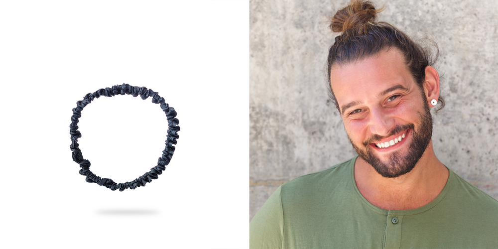 Smiling man with top bun is wearing Malkiele designer silk hair tie.