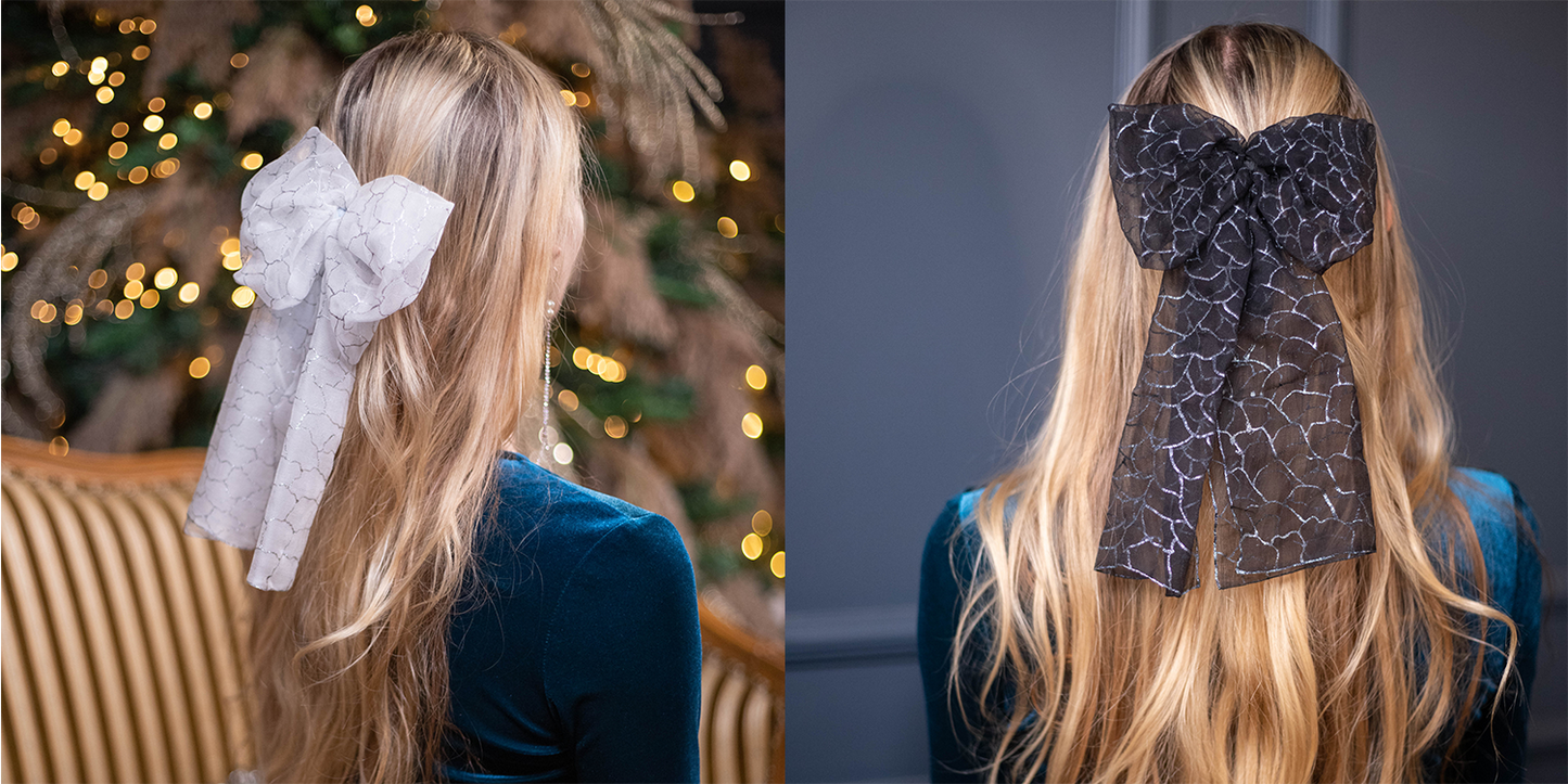 Set of two blonde-haired women are wearing art chiffon white and black bows.