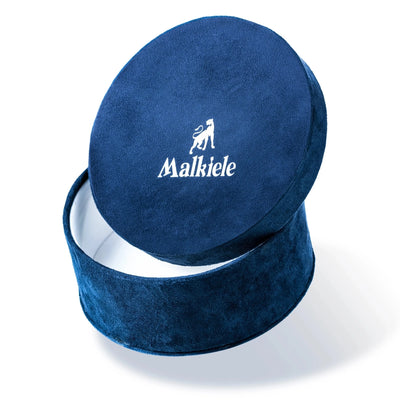 Malkiele designer, dark blue round velvet box with open cover, white lining, printed silver Malkiele logo and lioness on the cover, large size, name Adorable.