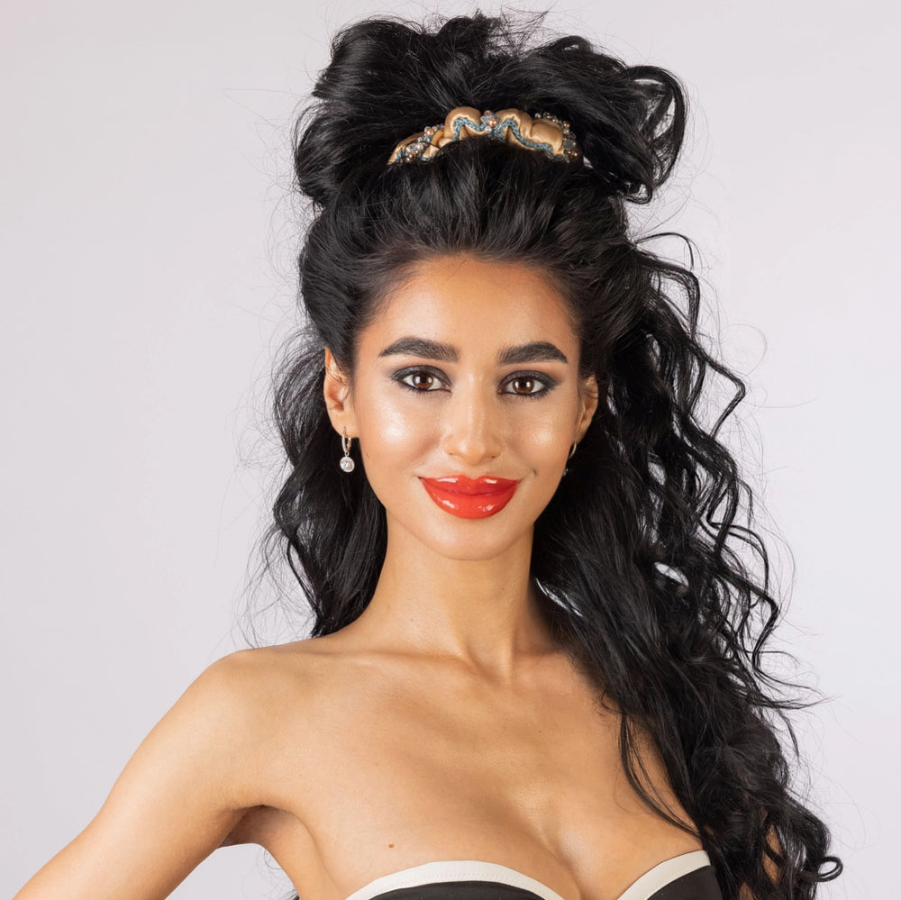 
                  
                    A black-haired girl, with stylish ponytail is wearing Malkiele designer beige silk scrunchie, embellished with crystals from Swarovski and green silk knit ribbon, name Elizabeth.
                  
                