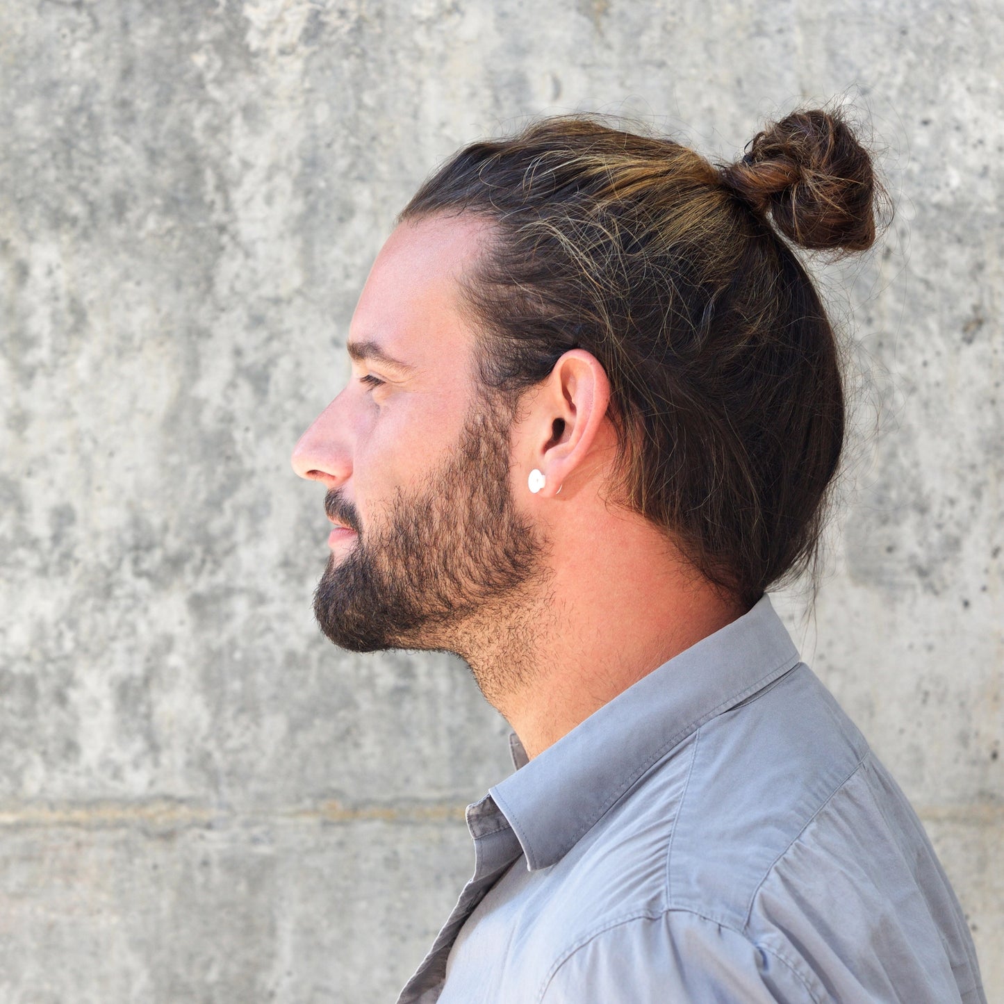 A man with a bun wears Malkiele silk hair tie, side view