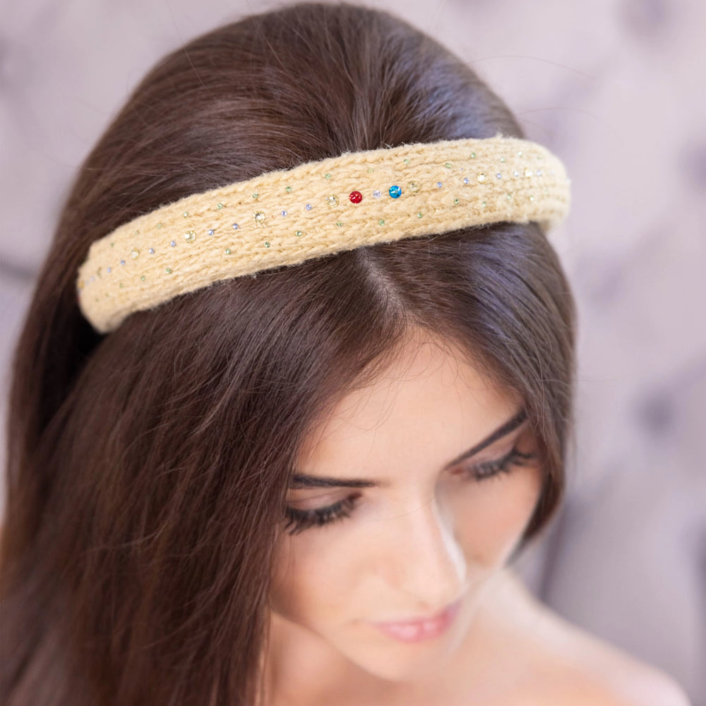 
                  
                    A dark-haired woman, is wearing Malkiele designer yellow silk knit headband, embellished with crystals from Swarovski, name Lofty.
                  
                