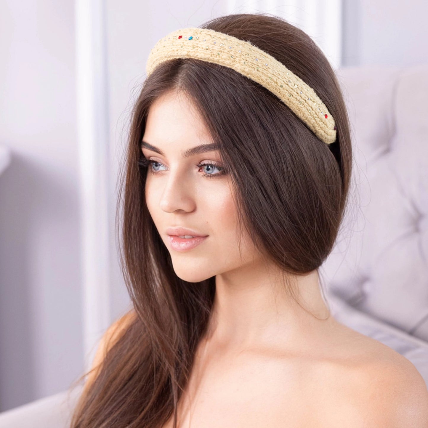 
                  
                    A dark-haired woman, is wearing Malkiele designer yellow silk knit headband, embellished with crystals from Swarovski, name Lofty.
                  
                