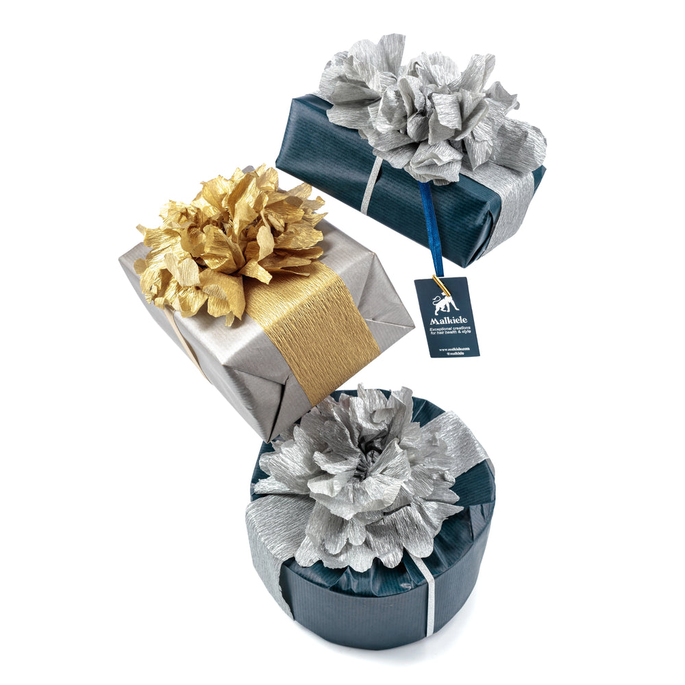 
                  
                    The set of three gifts in luxe wrapping, in blue, silver and gold colors, Malkiele sustainable designer.
                  
                