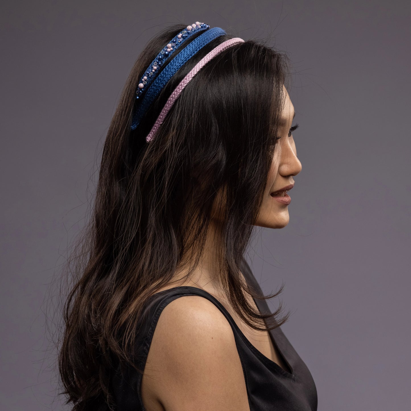 
                  
                    A dark-haired asian woman is wearing Malkiele silk knit headbands in blue, name Perfect
                  
                