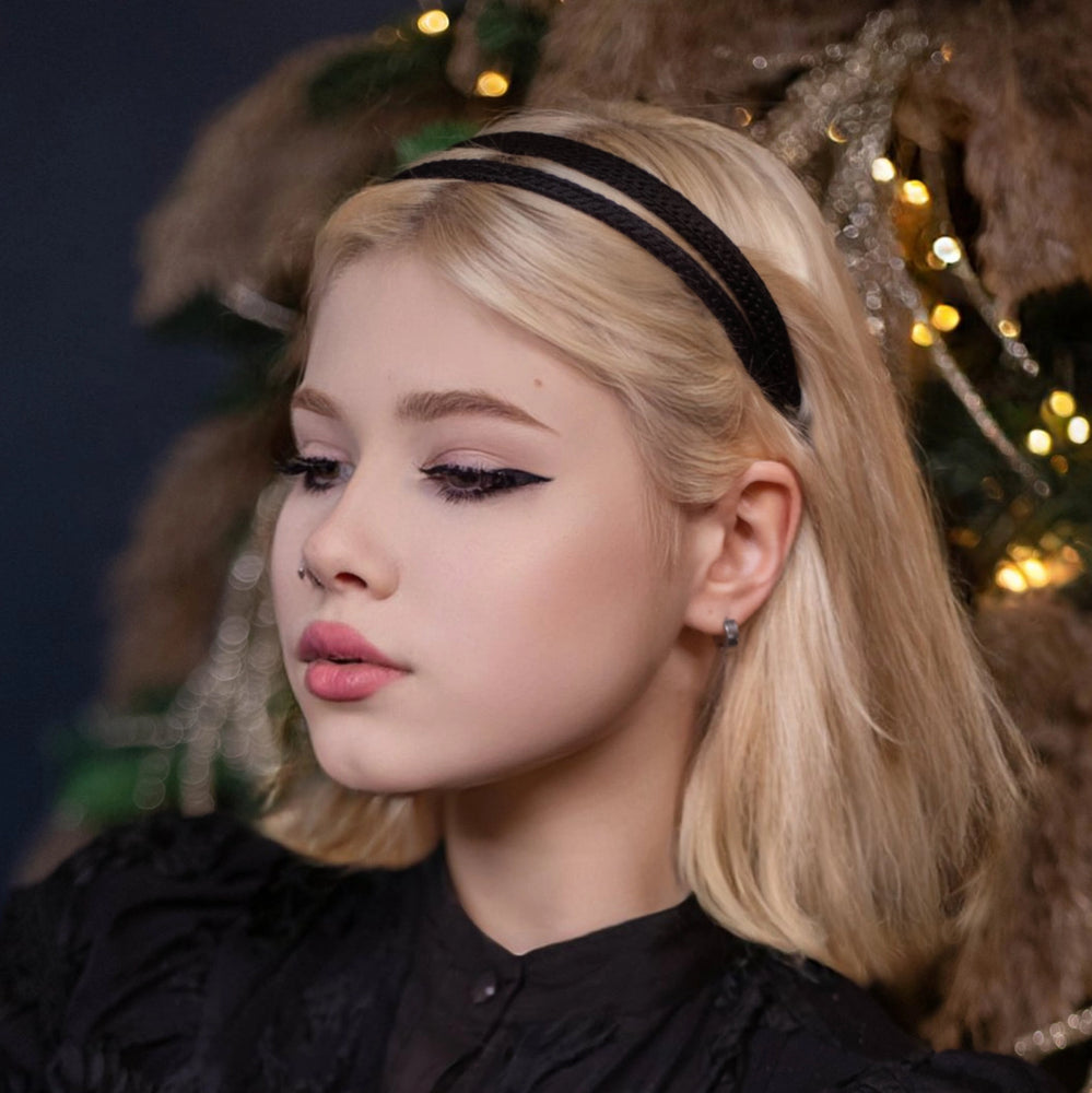 A blonde-haired girl is wearing Malkiele silk knit headband in black, name Virgin