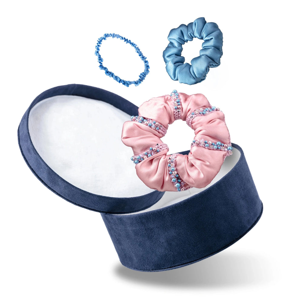 Malkiele designer, gift set consists of dark blue round velvet box with open cover, light blue silk hair tie, light blue silk scrunchie and pink silk scrunchie, embellished with crystals from Swarovski®, name Sumptuous.